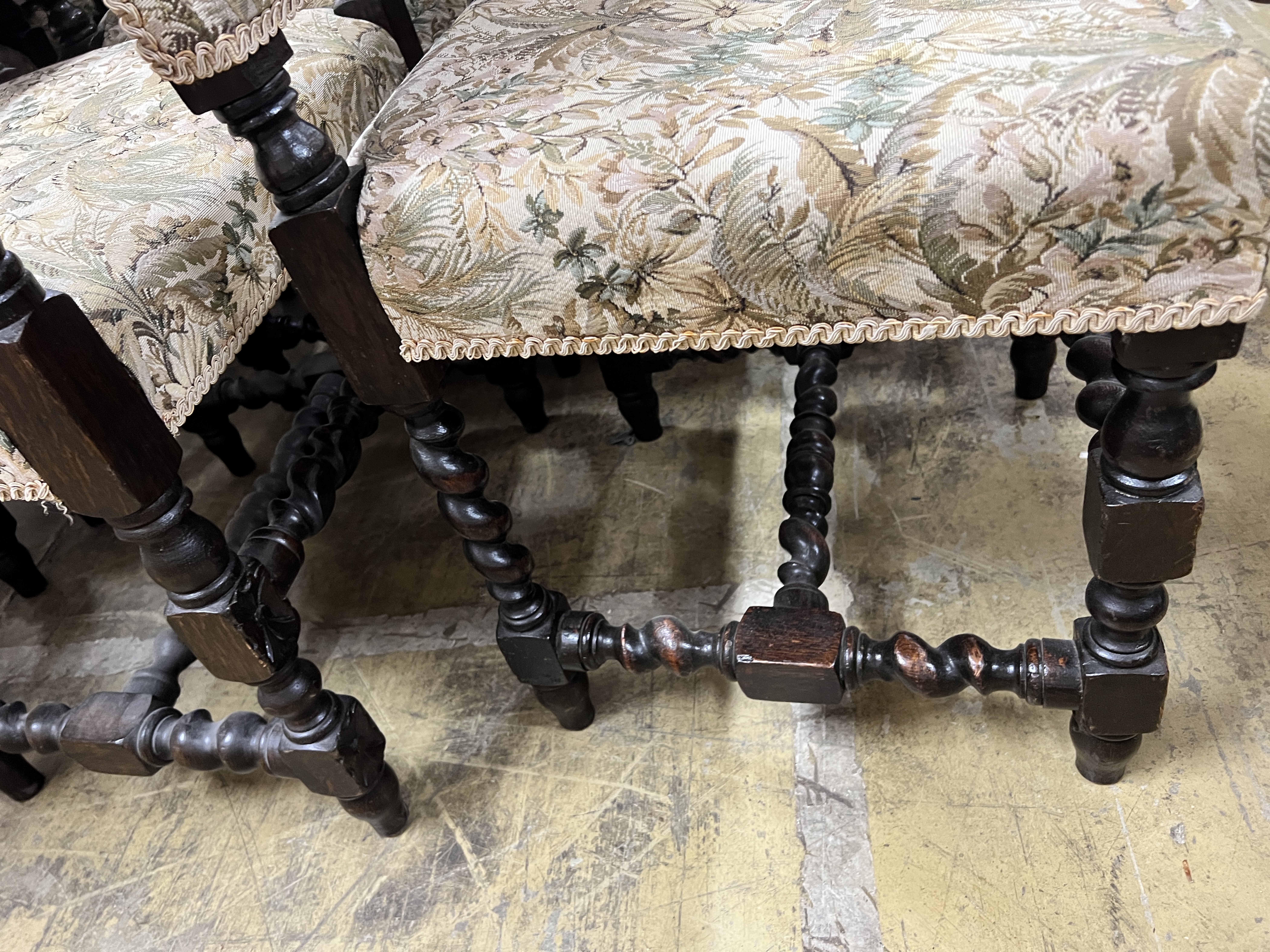 A set of seven 18th century style oak dining chairs, two with arms